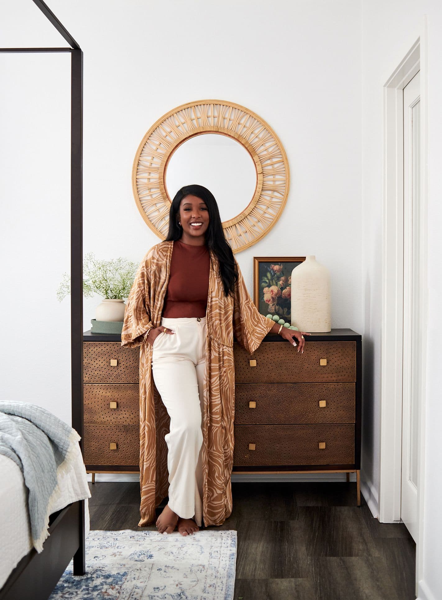 Enass, owner of Studio Enass standing next to renovated bedroom.